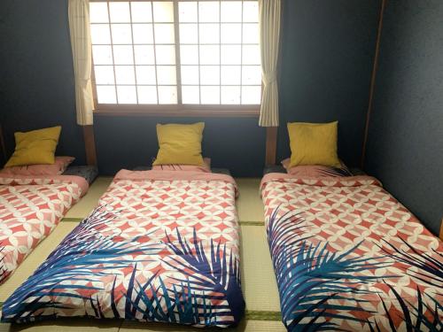 Ένα ή περισσότερα κρεβάτια σε δωμάτιο στο Furinkyo・楓林居 5号館