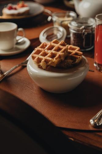 a plate of waffles on a wooden table at Castello di Limatola in Limatola