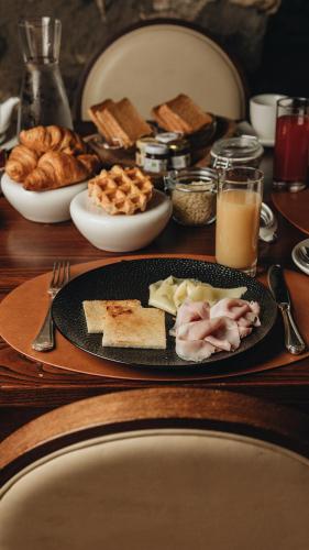 a wooden table with a plate of food and bread at Castello di Limatola in Limatola