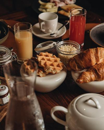 a wooden table with breakfast foods and drinks on it at Castello di Limatola in Limatola