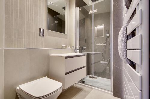 a bathroom with a toilet and a sink and a shower at Luxury 2 bed 2 bath Apartment in Canford Cliffs