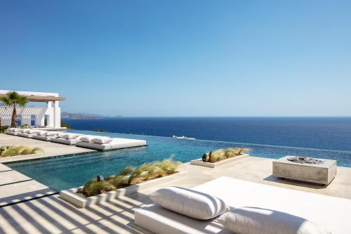 a swimming pool with a view of the ocean at Pure C in Vathi
