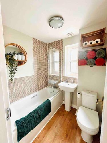 a bathroom with a tub and a toilet and a sink at Ty Lafant in Abergavenny