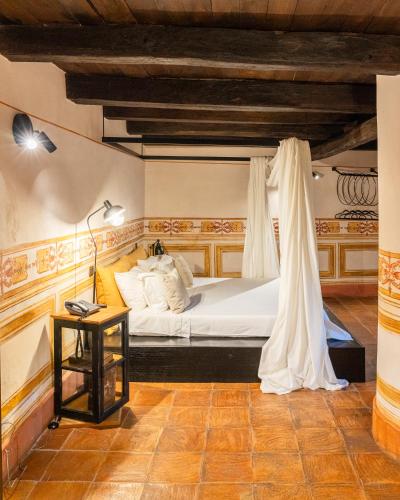 a bedroom with a white bed with a canopy at Castello di Limatola in Limatola