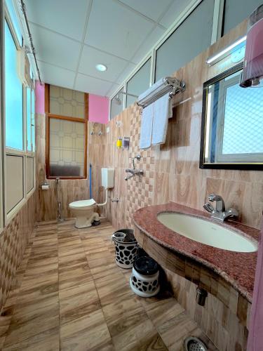 a bathroom with a sink and a toilet at Beena Homestay in Jaipur