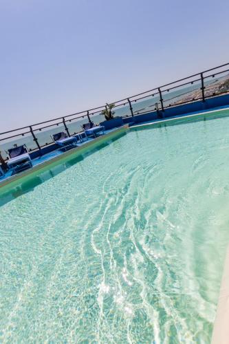 a large pool of water with chairs in it at Hotel Royal in Fermo