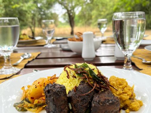 a plate of food with meat and eggs on a table at Big Game - Wilpattu by Eco Team in Wilpattu