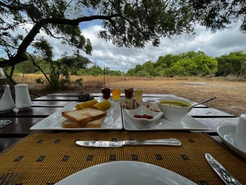 a table with a plate of food on it at Big Game - Wilpattu by Eco Team in Wilpattu