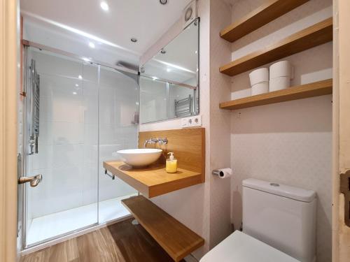 a bathroom with a toilet and a sink and a shower at APARTAMENTO Delia in Gijón