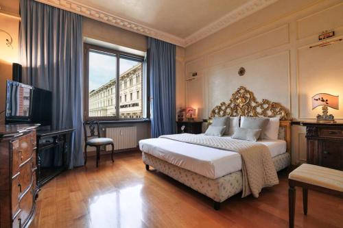 a bedroom with a large bed and a large window at centro extra luxory apartment with terrace in Milan