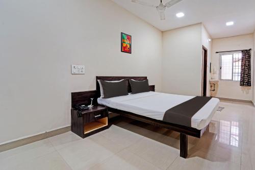 a bedroom with a large bed in a room at Collection O G Silver Near Airport in Chennai