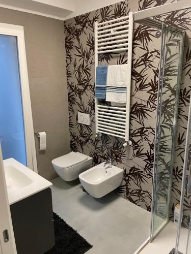 a bathroom with a toilet and a sink at Pindemonte house in Quartu SantʼElena