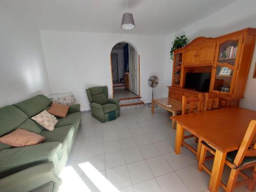 een woonkamer met een bank en een tafel bij La Almadraba in Novo Sancti Petri
