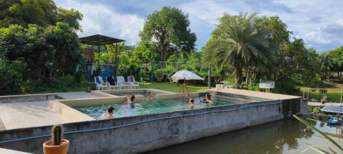 a group of people in a swimming pool at JJ&J Garden in Pai