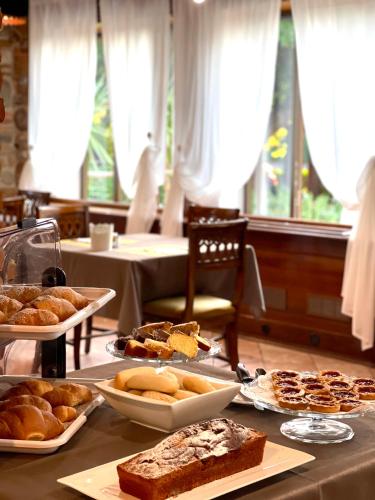 a table topped with different types of bread and pastries at Alla Favorita in Bassano del Grappa