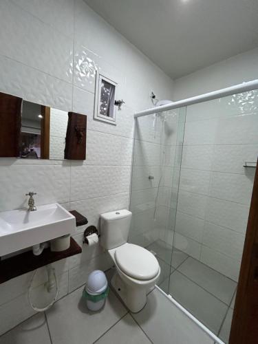 a bathroom with a toilet and a shower and a sink at Urubici Casa Copacabana in Urubici