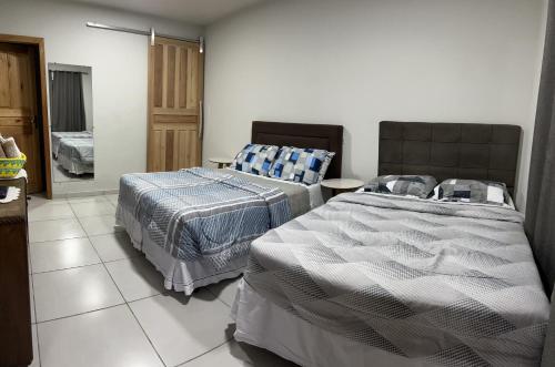 Ένα ή περισσότερα κρεβάτια σε δωμάτιο στο Urubici Casa Copacabana