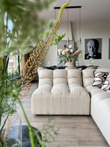 a living room with a white couch and a table at Short Stay Waterpoort in Sneek
