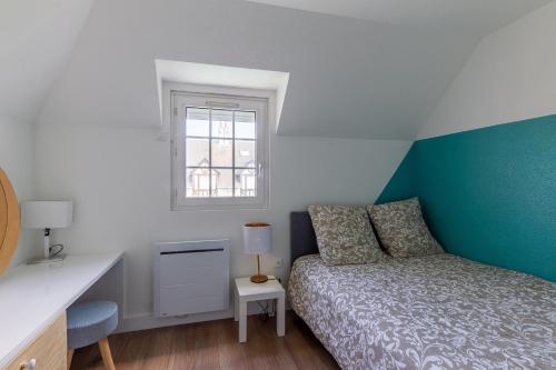 Azul - Maison avec jardin à 200m de la plage في كورسول-سور-مار: غرفة نوم صغيرة بها سرير ونافذة