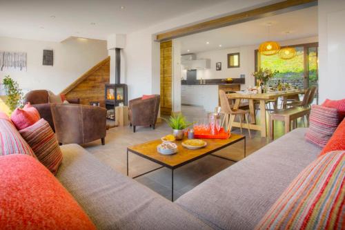 a living room with a couch and a table at Chalet Zamaro - OVO Network - OVO Network in La Clusaz