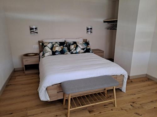 a bedroom with a large bed with a wooden floor at Maison Maurer 