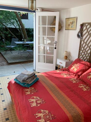 a bedroom with a bed and a sliding glass door at Villa Akwaba in Pyla-sur-Mer