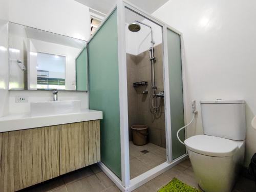 a bathroom with a toilet and a sink and a shower at ～ Sea You in Paradise: Pico de Loro Hamilo Coast ～ in Nasugbu