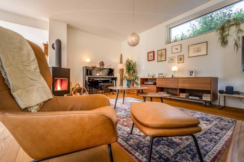 a living room with a couch and a table at Bauhausvilla am Ammersee in Herrsching am Ammersee