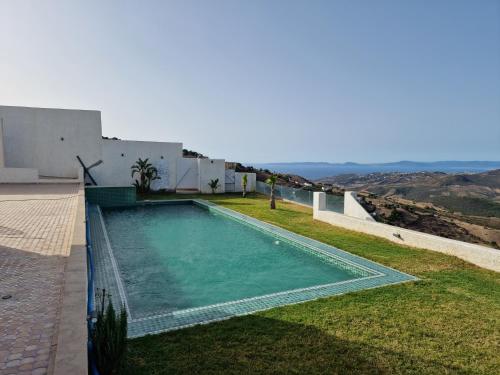 a swimming pool on the side of a house at Villa avec vue exceptionnelle in Tangier