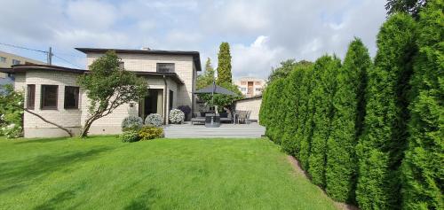 a house with a yard with green grass at Elly House in Haapsalu