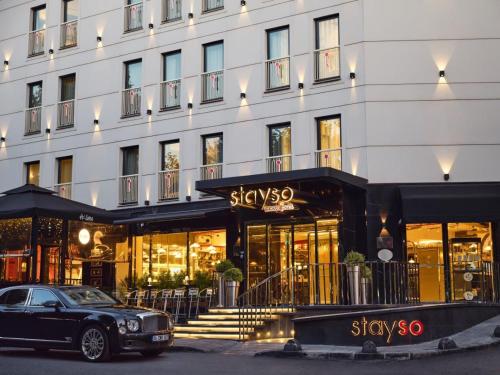 a black car parked in front of a building at Stayso The House Hotel in Istanbul