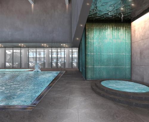 a swimming pool in a building with a fountain at Crowne Plaza Sofia, an IHG Hotel in Sofia