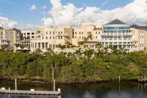 a large building next to a body of water at Wyndham Grand Jupiter at Harbourside Place in Jupiter