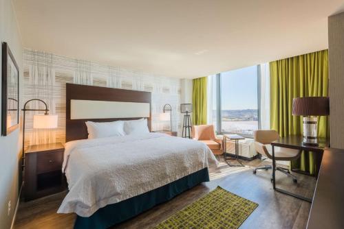 a hotel room with a bed and a desk and a room at Hampton Inn & Suites Washington, D.C. - Navy Yard in Washington