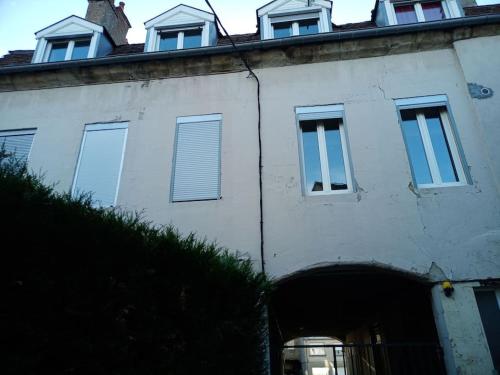 a white building with windows on top of it at Autun cœur de ville in Autun