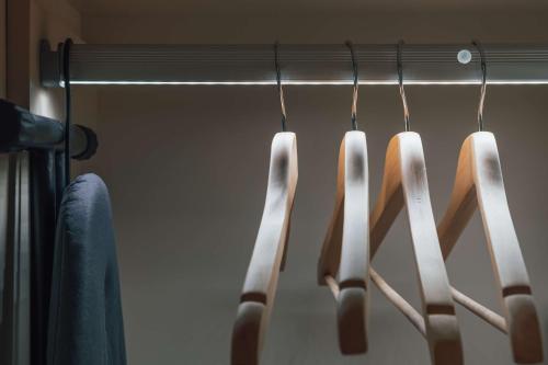a group of knives hanging on a rack in a closet at Radisson Blu Hotel Riyadh Convention and Exhibition Center in Riyadh