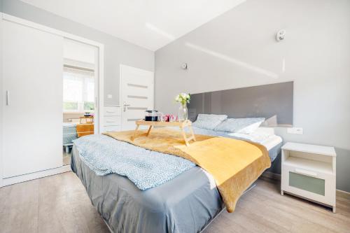 a bedroom with a large bed with a table on it at Orientarium Business Apartments with Parking by Rentujemy in Łódź