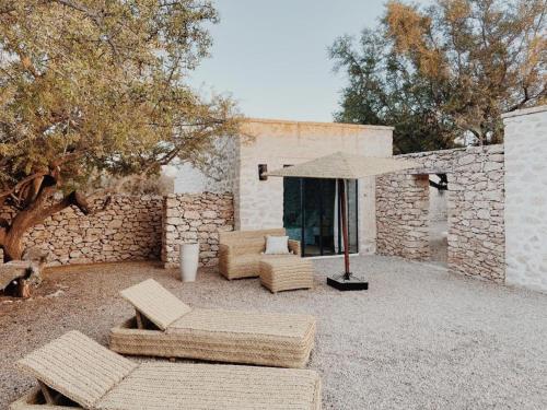 a patio with two couches and an umbrella at Maison Belhazar in Essaouira