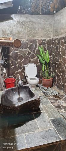 a bathroom with a sink and a toilet at Mengalung Bungalow in Kuta Lombok