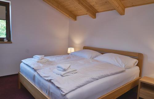 a bedroom with a bed with white towels on it at Golf Resort Lázně Bohdaneč in Lázně Bohdaneč