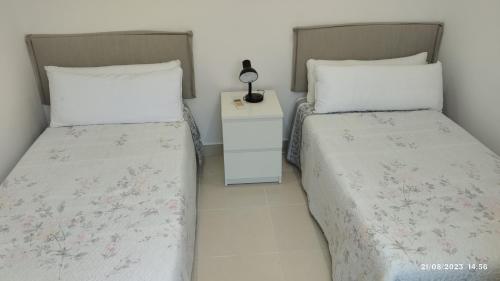 two beds sitting next to each other in a bedroom at Apartamento Agradable1 in Madrid