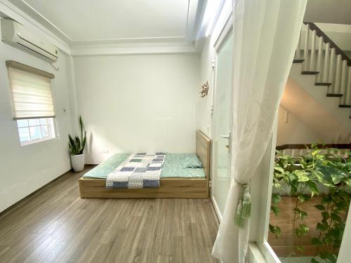 a bedroom with a bed and a staircase at Green Homestay in Hanoi
