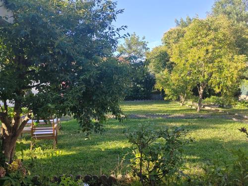 a park bench sitting in the middle of a field at Emplacement nu sur Bayonne pour tentes dans jardin clos et privé in Bayonne