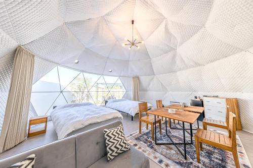 een slaapkamer met een gewelfd plafond met een bed en een tafel bij Innocence Resort -in Chiba Resol- in Hasunuma