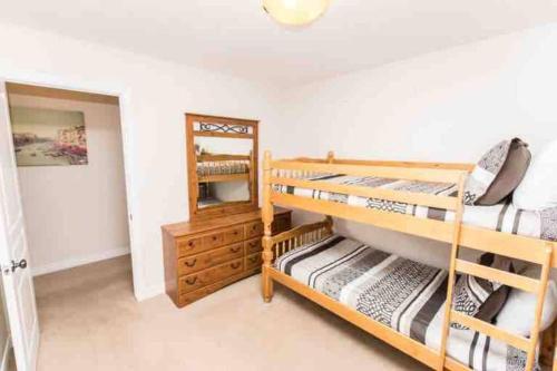 a bedroom with two bunk beds and a mirror at Beautiful Fallsview Home in Niagara Falls
