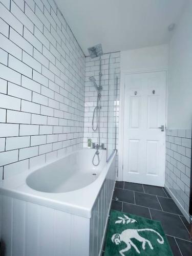 a white bathroom with a tub and a horse rug at Newly refurbished 3 bed house in Hull