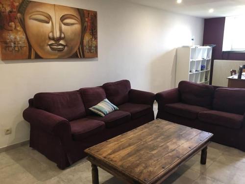a living room with a couch and a coffee table at La Casa Kemtio in Nollevaux