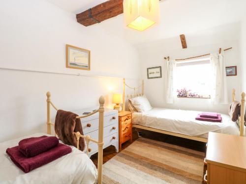 a bedroom with two beds and a window at Garden House in Thetford