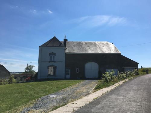 a black and white building with a grey roof at La Casa Kemtio in Nollevaux