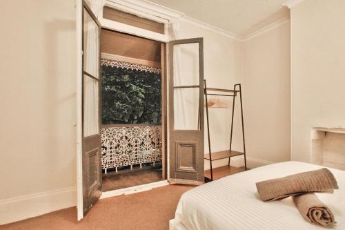 a bedroom with a door leading to a balcony at 3 Bedrooms - Darling Harbour - Glebe St 2 E-Bikes Included in Sydney